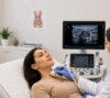 Doctor performing a thyroid ultrasound scan on a female patient to diagnose thyroid nodules.